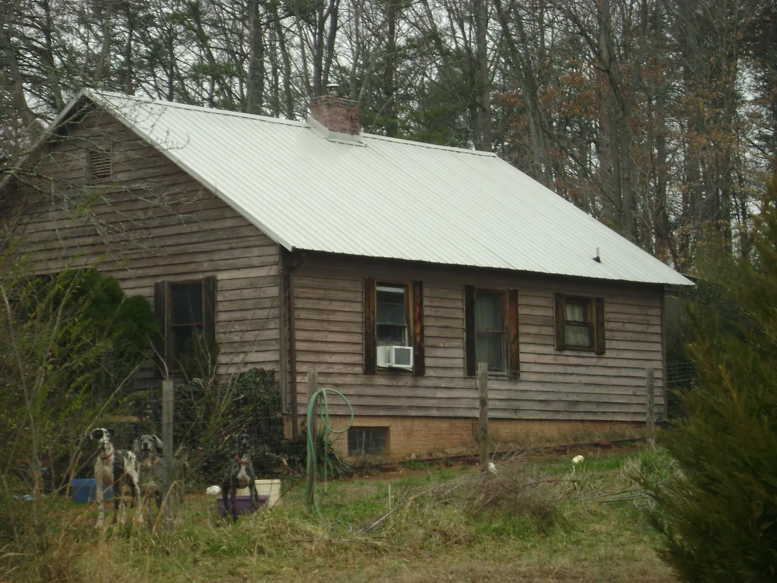 White metal roof on an old wood sided farmhouse, from a Metal Roof Installation job in Sewell